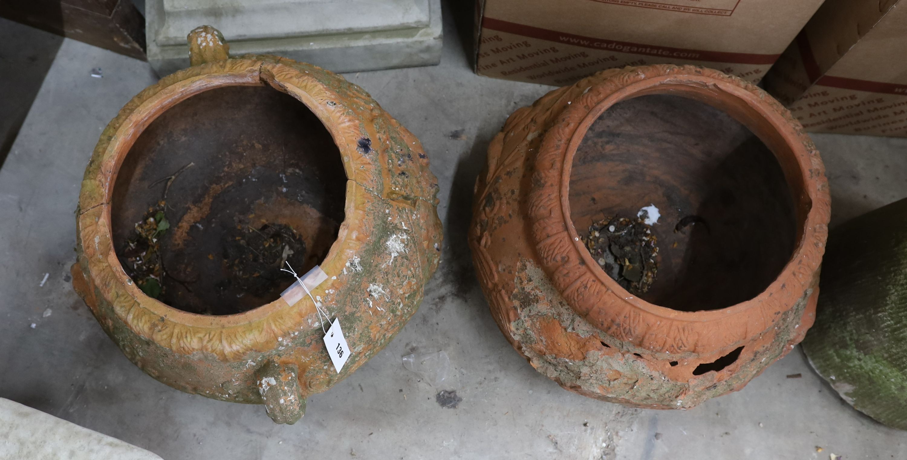 A pair of circular terracotta garden planters, diameter 50cm, height 34cm (damaged)